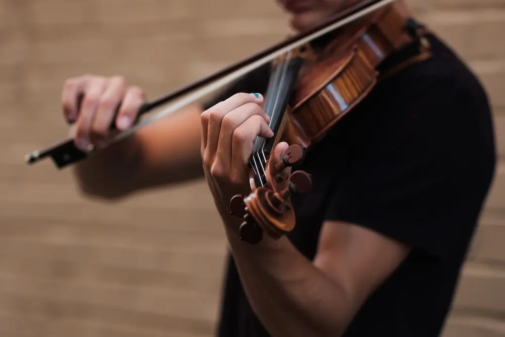 male student playing violin
